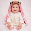 Baby boy wearing traditional white thobe with red checkered headscarf