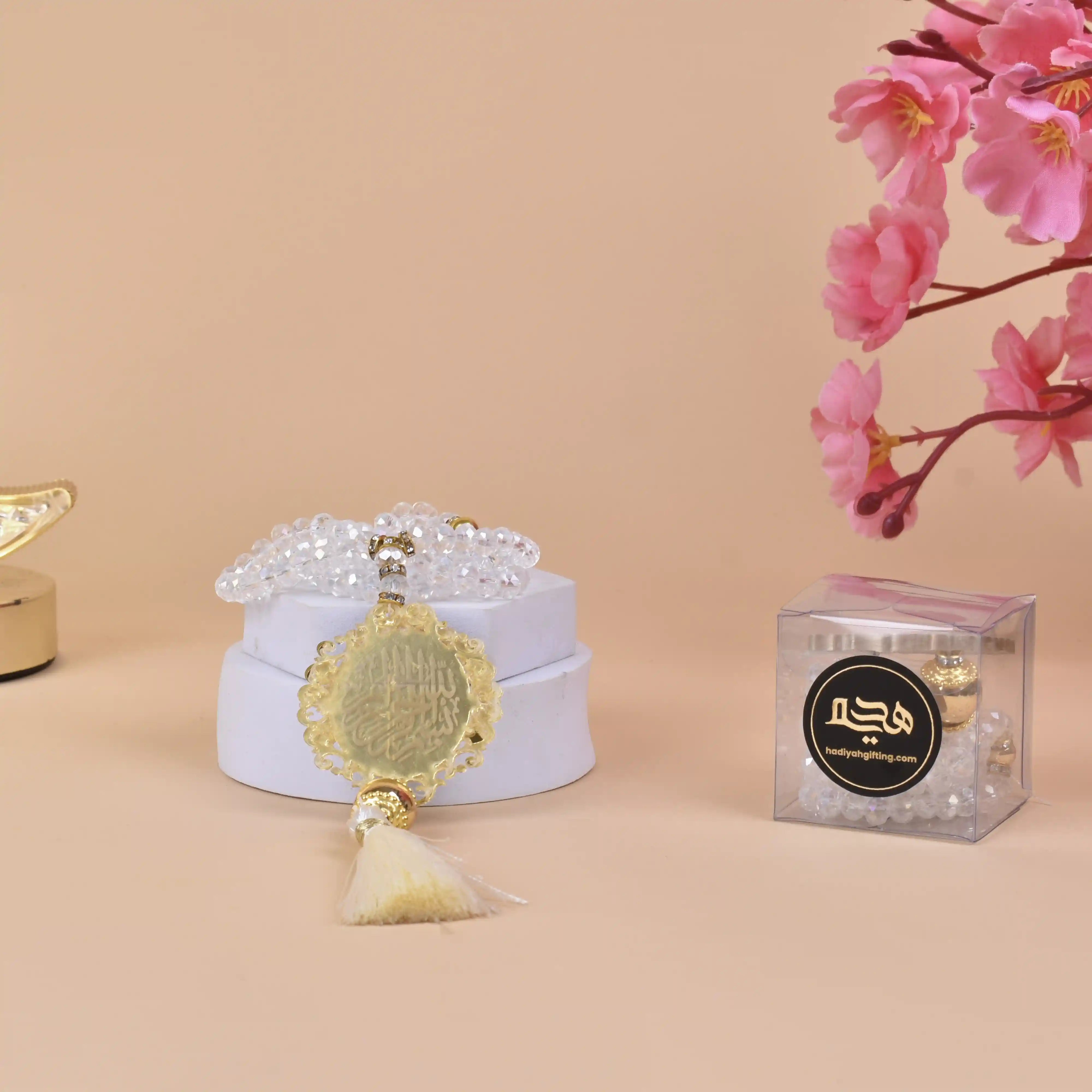 White Crystal Tasbeeh with 100 beads and gold Bismillah charm displayed on a white box, ideal Islamic gift for prayer and special occasions. Main image
