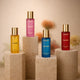Set of colorful perfume bottles on beige pedestals for luxury fragrance display