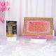 Close-up of Quran with gold calligraphy and pink background