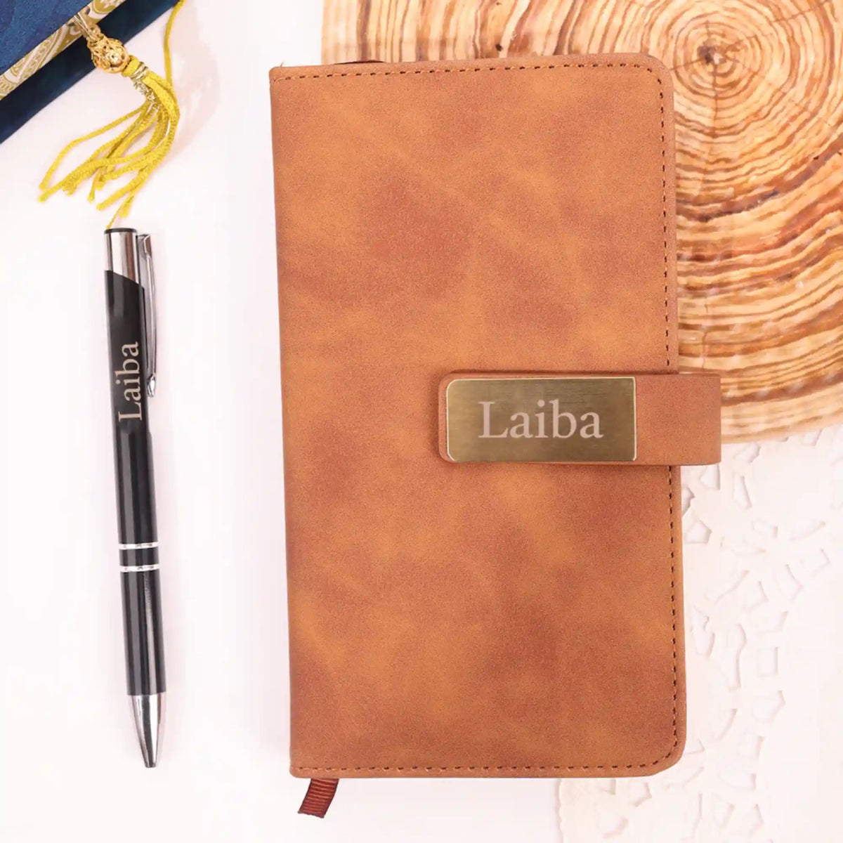 Brown leather diary with gold label inside a blue floral gift box