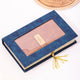 Brown leather diary with gold label in a blue floral gift box