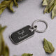 Close-up of personalized engraved keychain with leafy decor