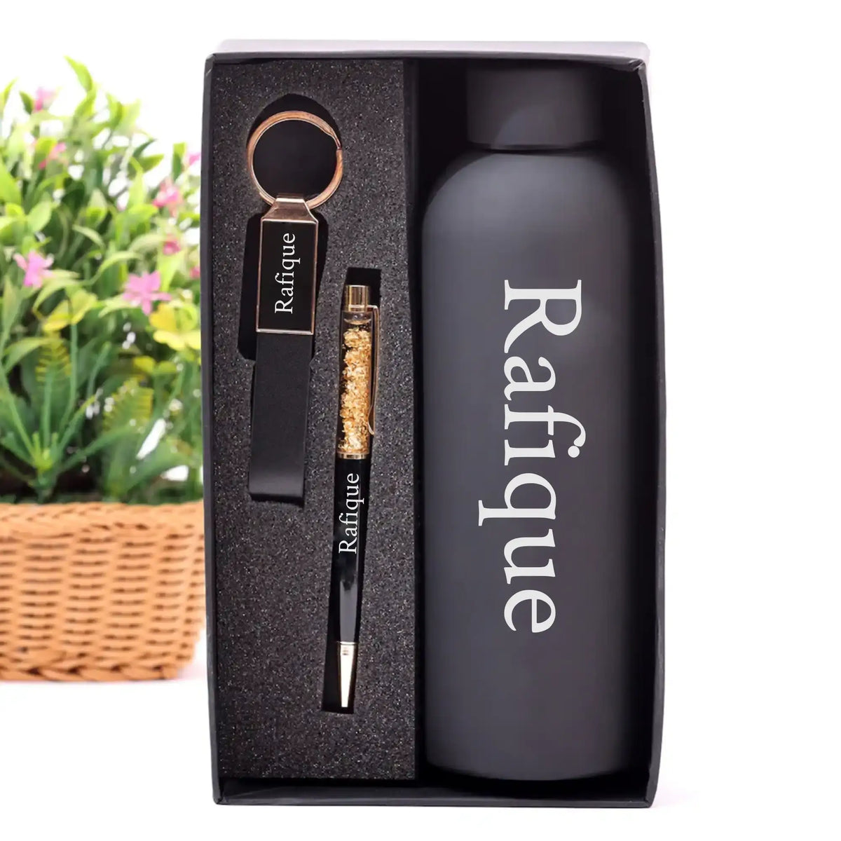 Close-up of personalized keychain, pen, and bottle in gift box