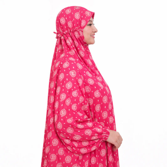 Side view of woman in pink printed prayer dress