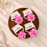 Haldi e Haya Floral Favors featuring pink floral hand bracelets with pearl bands and custom 'Aliya ki Haldi' cards, ideal for wedding celebrations.