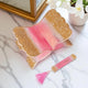 Elegant foldable pink sequence Rehal with gold accents and tassel bookmark, perfect for Quran recitation and decorative book display.