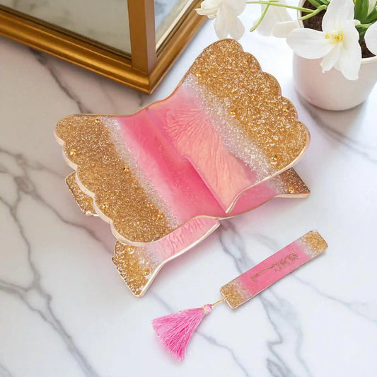 Elegant foldable pink sequence Rehal with gold accents and tassel bookmark, perfect for Quran recitation and decorative book display.