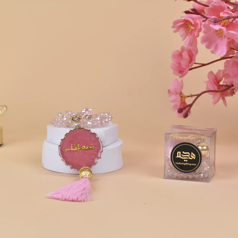 Pink Crystal Tasbeeh Name - Personalized Crystal 100 Beads displayed with floral decor and gift box, ideal for gifting and spiritual use. Main image