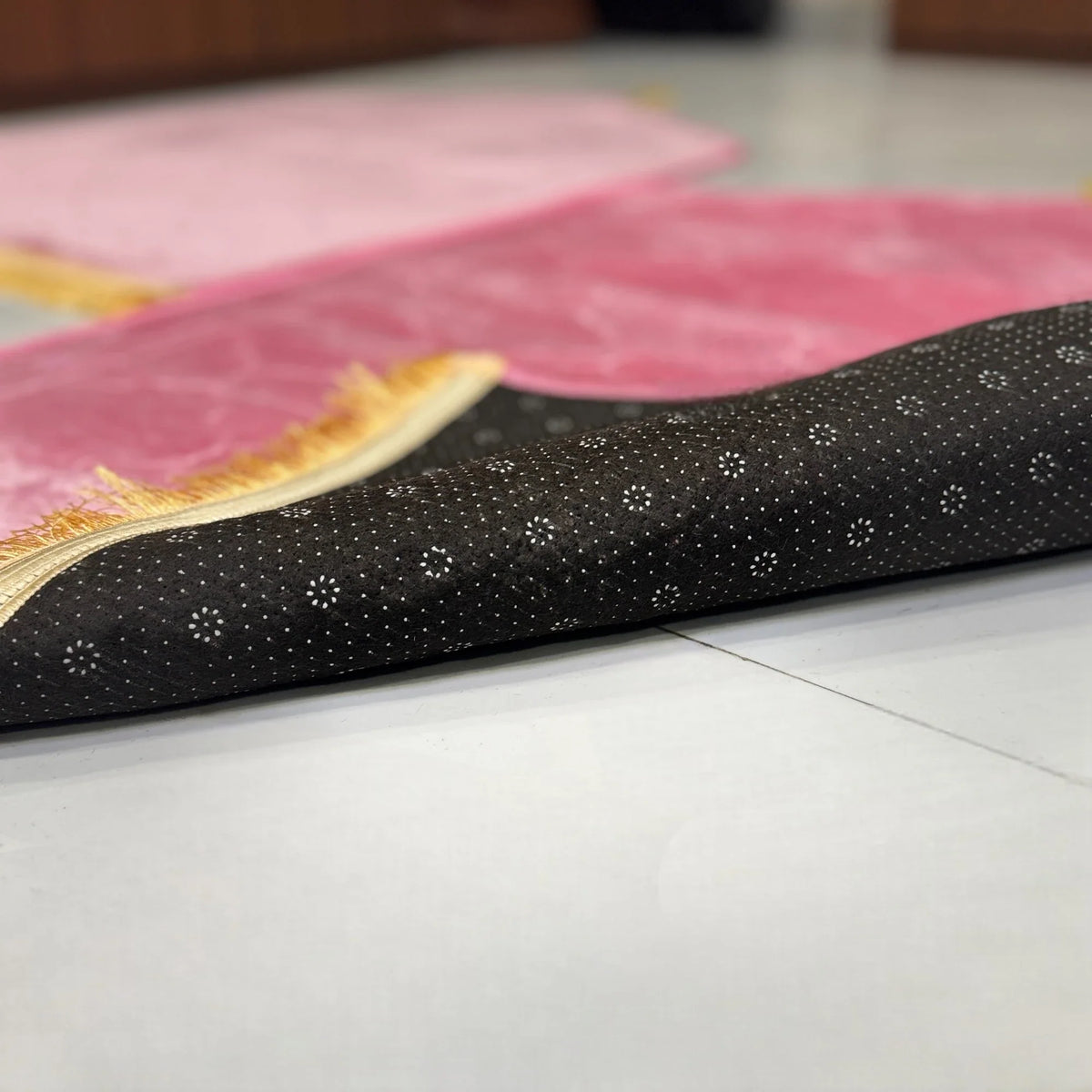 Underside of Couple Janamaz showing anti-slip dotted base for stability. High-quality dome prayer mats for daily or ceremonial use.