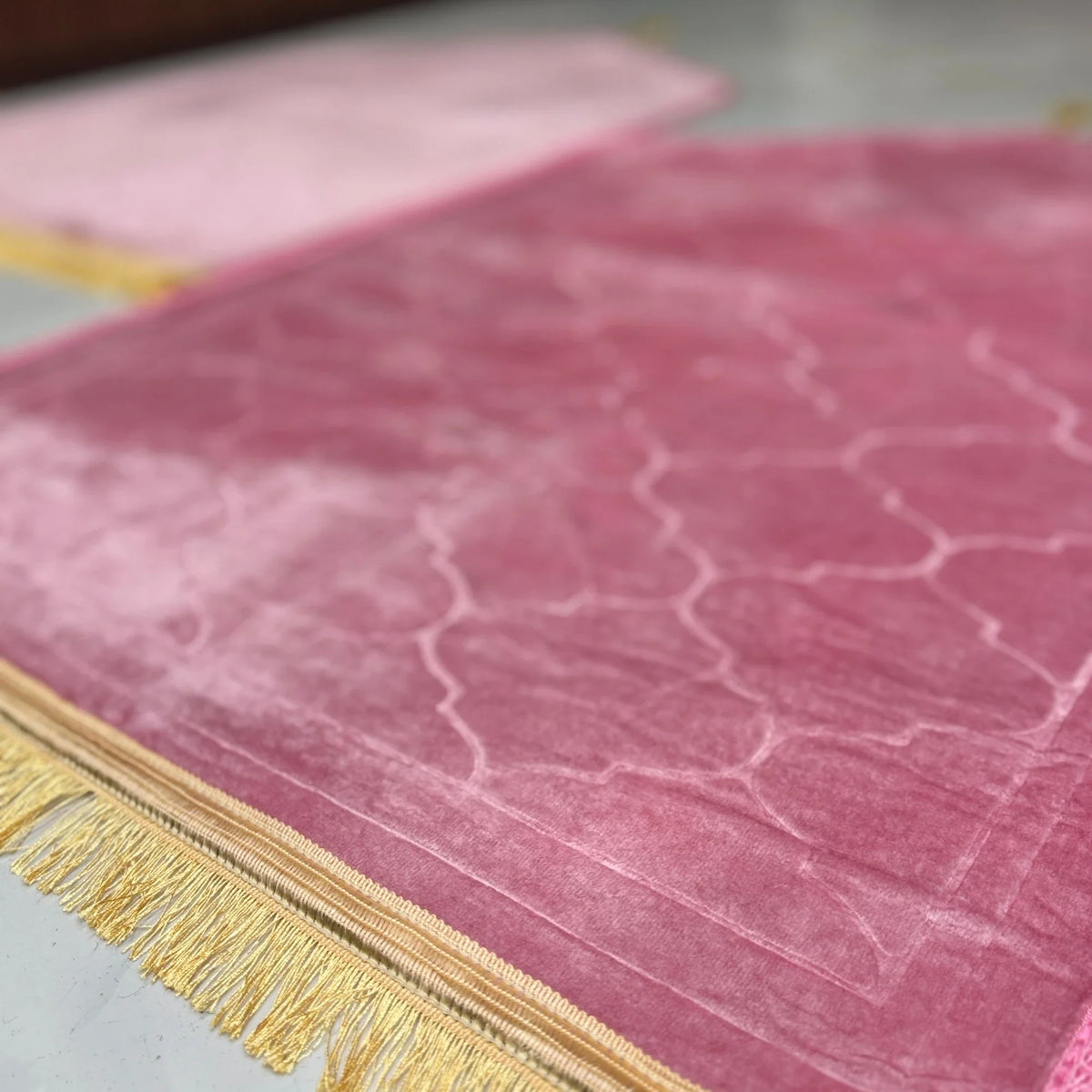 Side view of Dome Prayer Mats in pink tones with golden fringe, highlighting soft, durable fabric. Perfect for couple prayer rituals.