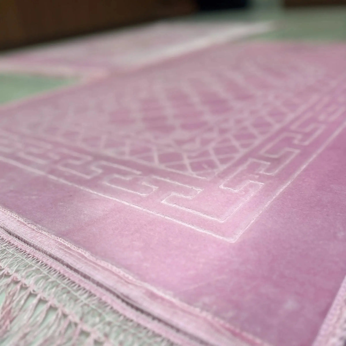 Close-up of elegant pink rectangle Couple Janamaz with intricate geometric design, showcasing soft texture and premium finish for prayer use.