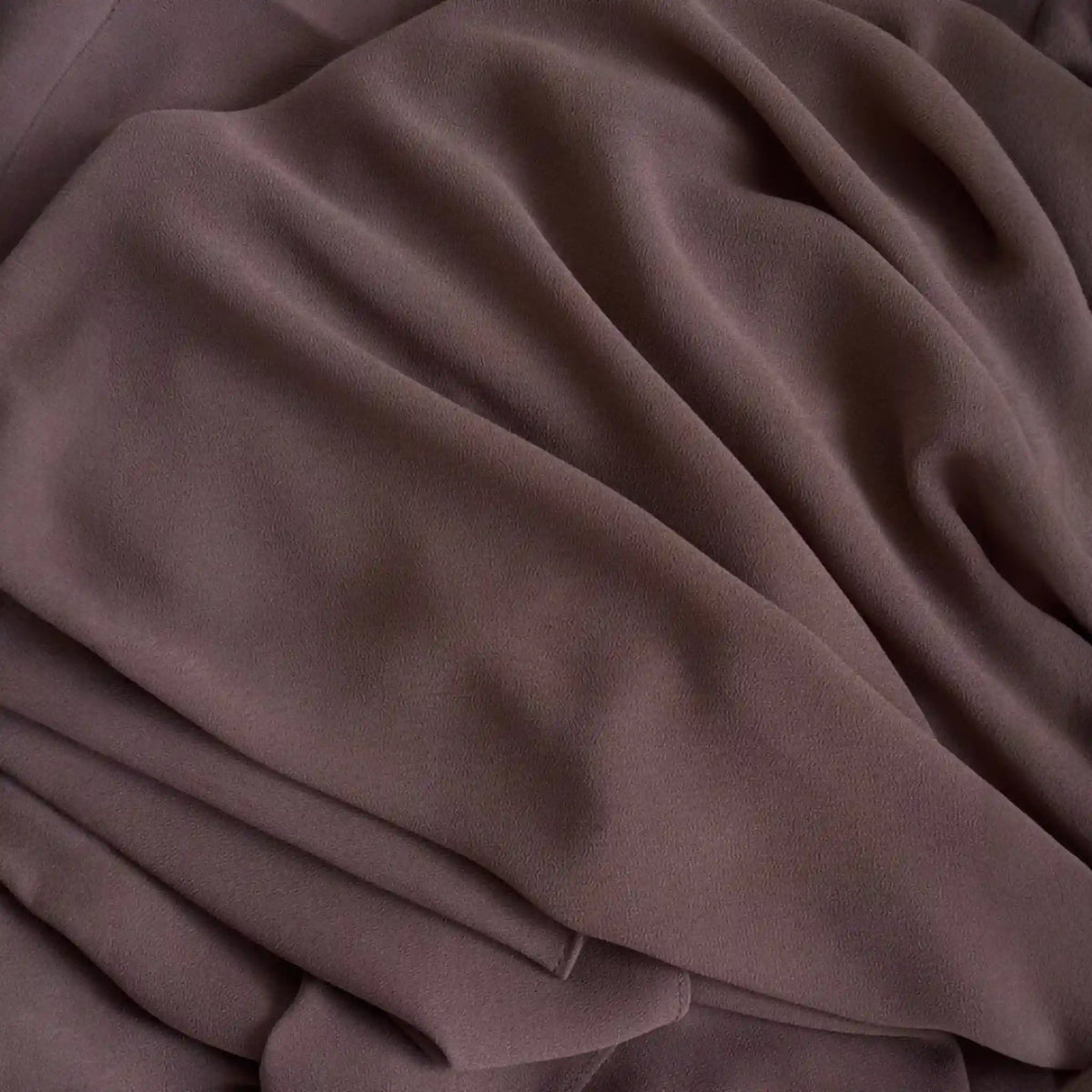 Close-up of brown fabric with folds