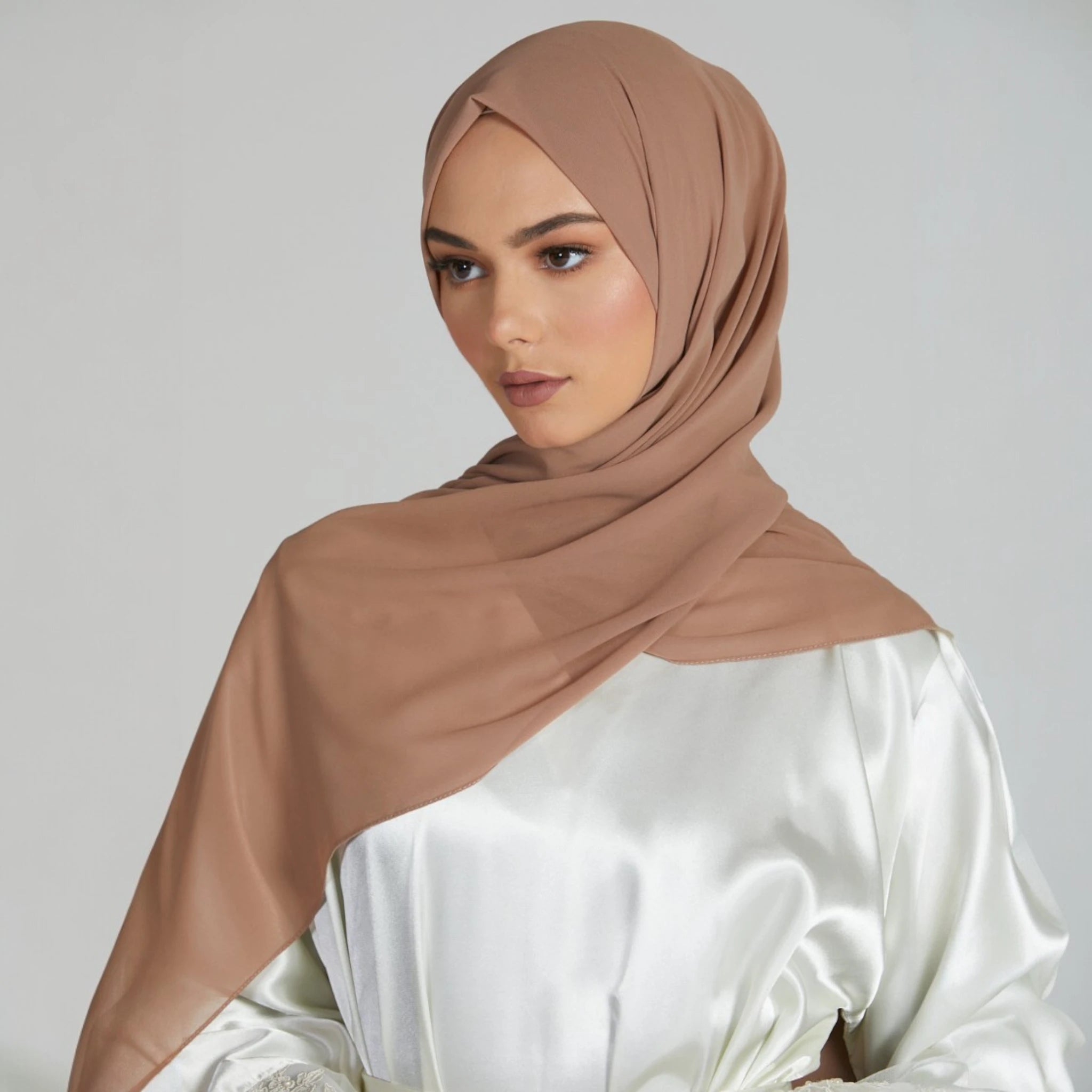 Biscotti Beige Chiffon Hijab styled on model with smooth, lightweight drape. Premium modest fashion headwear for elegant everyday wear. Main image