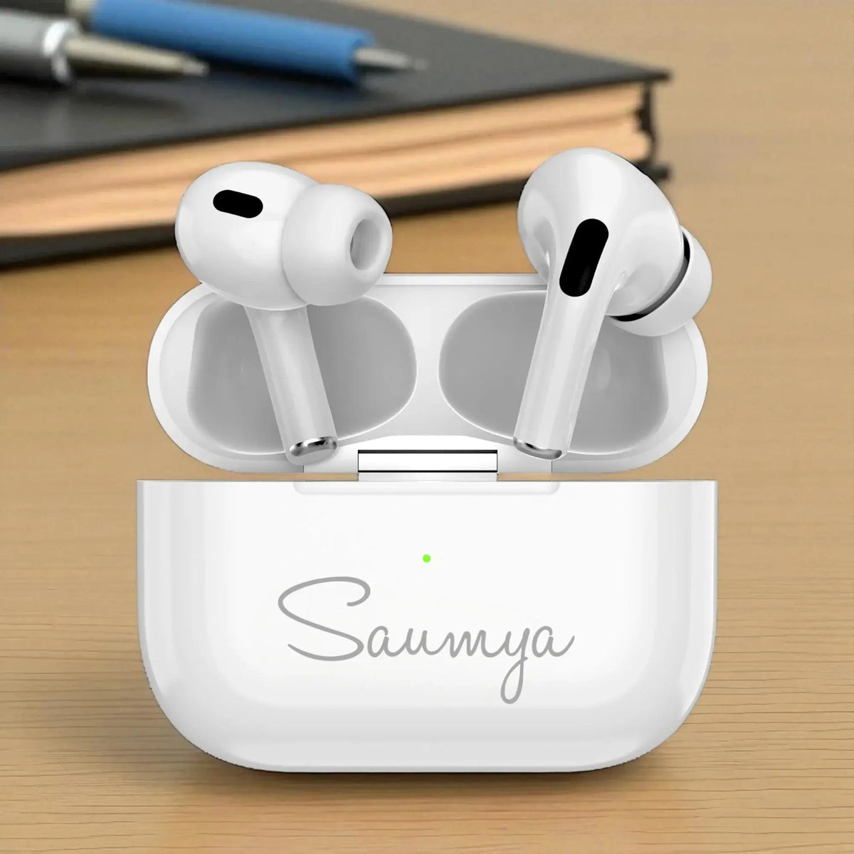 Pro Pods Wireless Earbuds in open charging case with personalized 'Saumya' engraving, showcasing sleek in-ear design and touch control sensors.