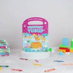 Children's book titled 'Prophet Yusuf' with colorful building blocks and crayons on a white background