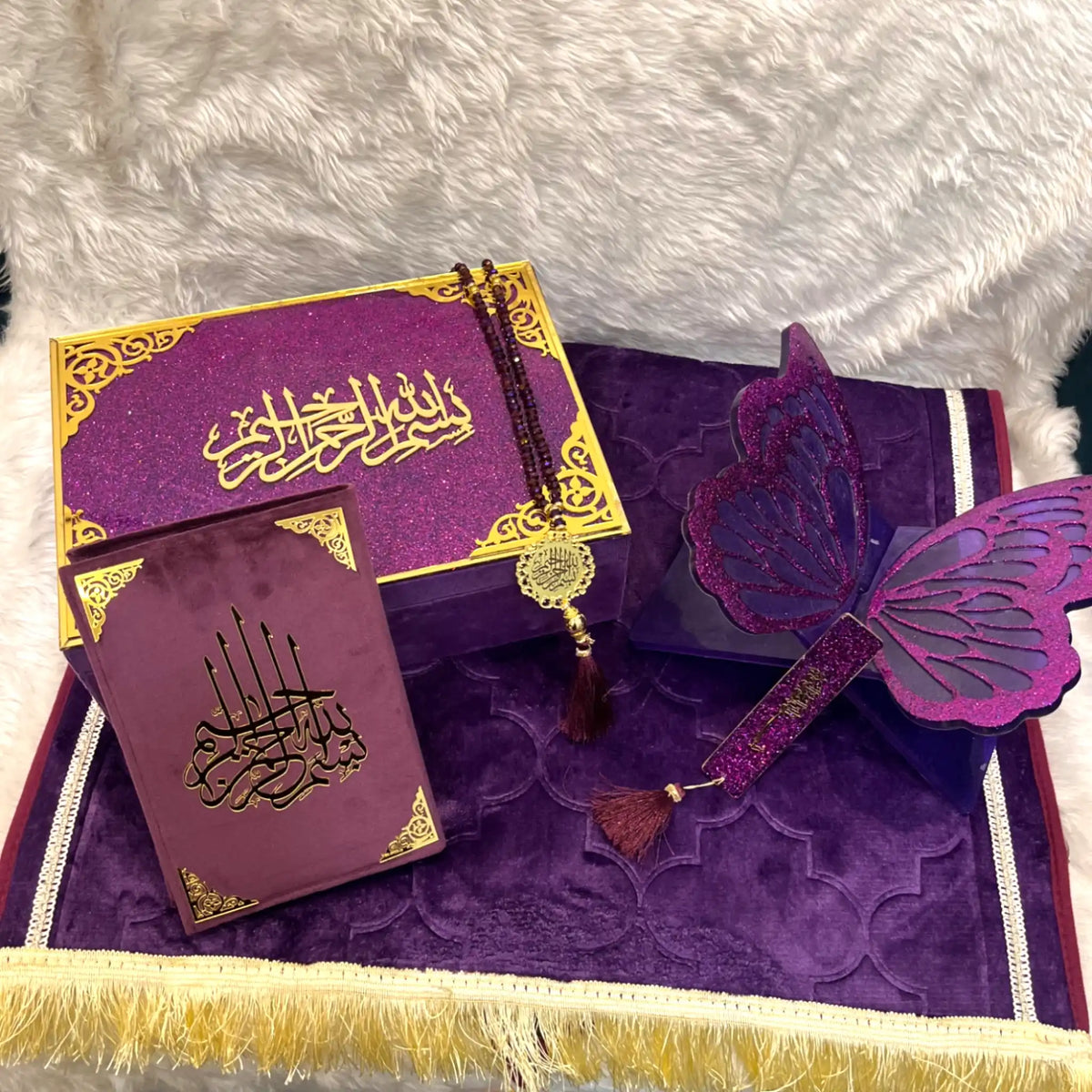 Purple and gold decorative items with intricate designs on a textured surface