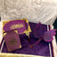 Purple and gold decorative items with a butterfly design on a textured surface