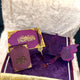 Purple and gold decorative item with intricate designs on a textured surface