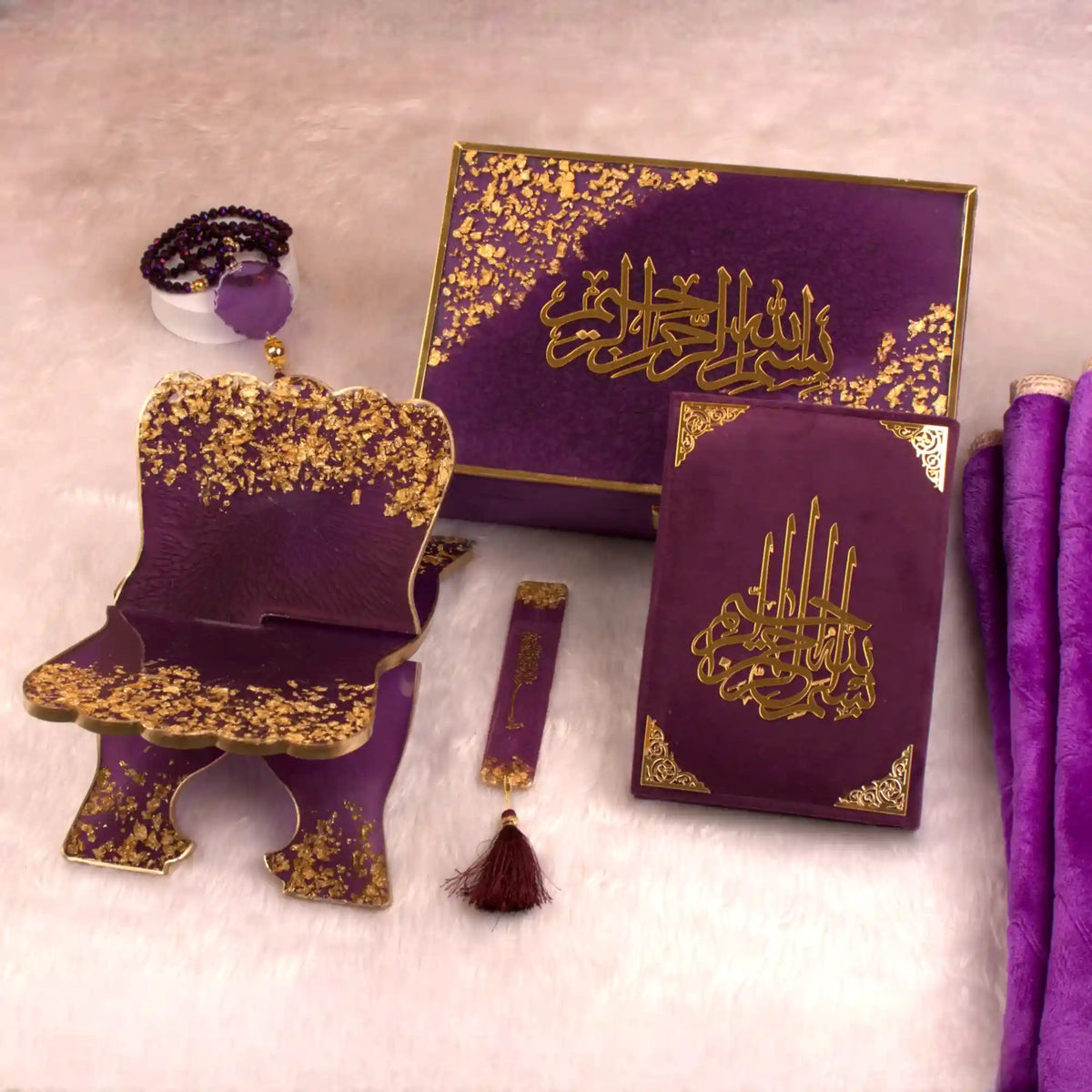 Purple and gold religious items including a book and chair on a light background