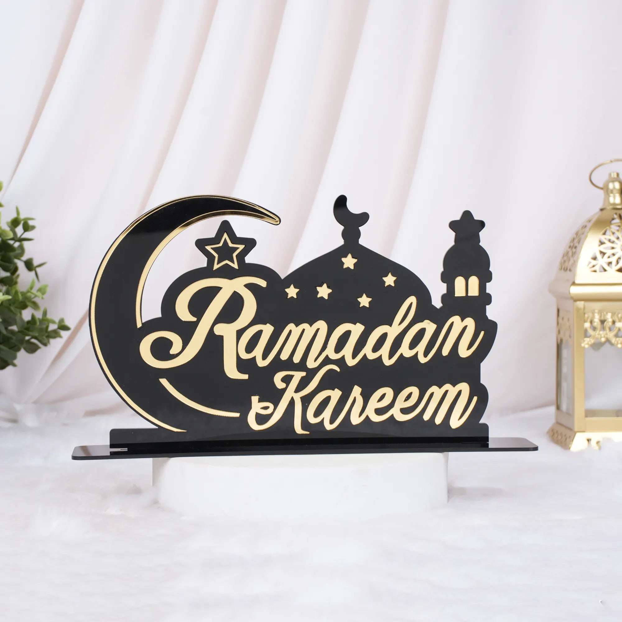 Decorative sign with 'Ramadan Kareem' text on a black base, featuring a moon and star design. Main image
