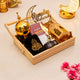 Decorative items for Ramadan on a wooden tray with gold and black colors.