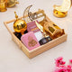 Decorative items for Ramadan on a wooden tray with 'Ramadan Mubarak' sign.