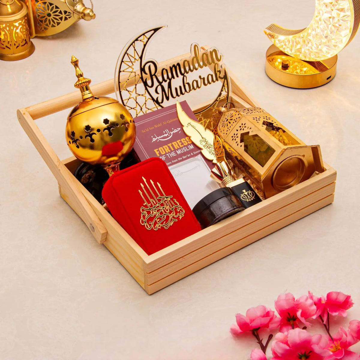 Decorative set with 'Ramadan Mubarak' sign, gold lantern, and red card on a beige background.