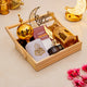 Decorative tray with Ramadan-themed items including a gold lantern, prayer rug, and 'Ramadan Mubarak' sign on a beige background.