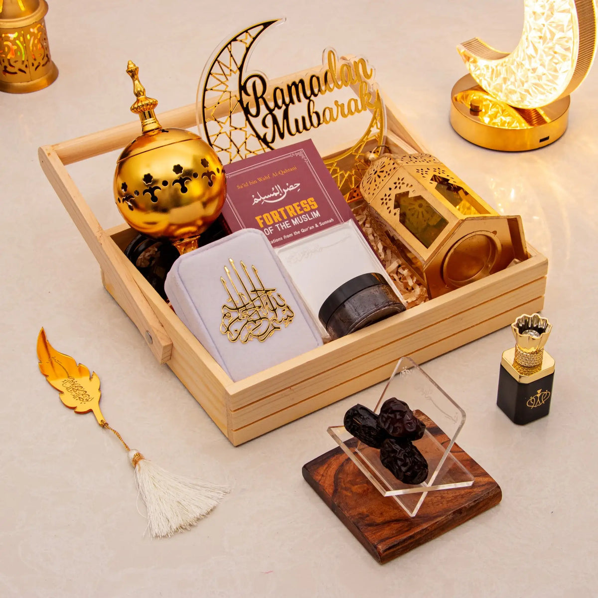 Decorative items for Ramadan with a wooden tray, gold lanterns, and Quranic text