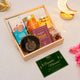 Gift set with cookies, almonds, and a card on a light background