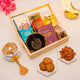 Gift basket with cookies, almonds, and a glass with 'Ramadan Mubarak' text on a light background.