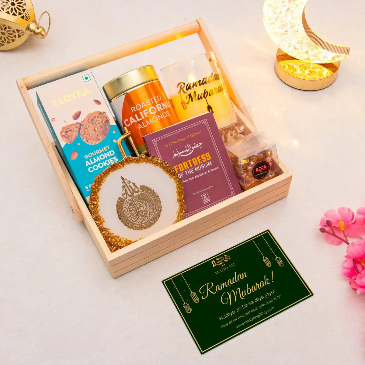 Gift basket with snacks and a Ramadan Mubarak card on a light background