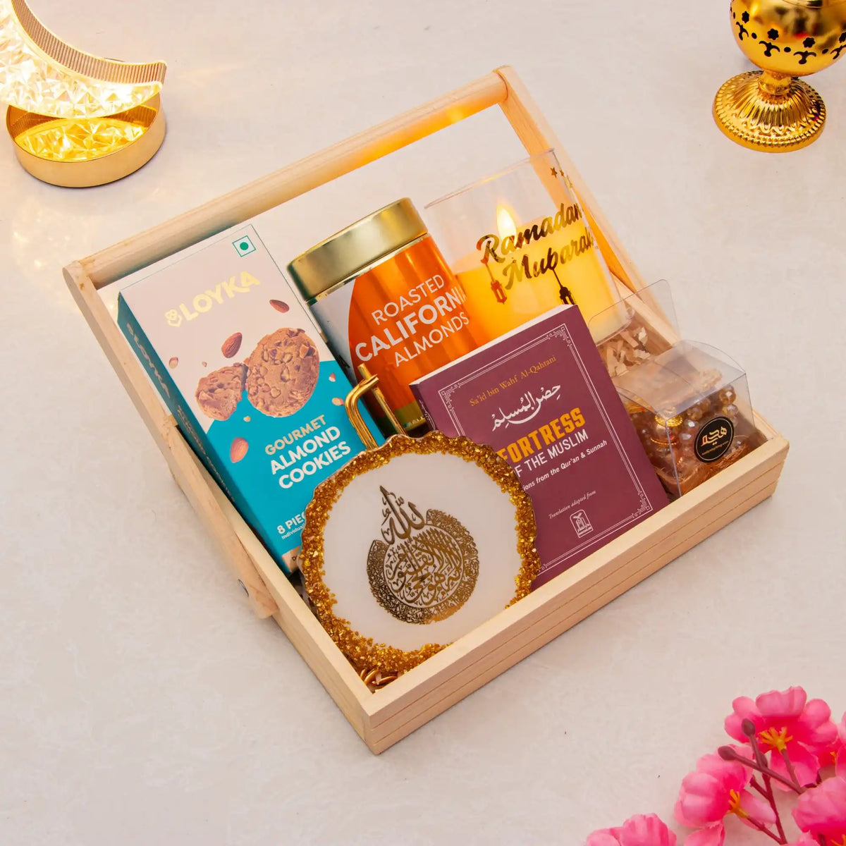 Gift basket with cookies, almonds, and a decorative item on a light surface.