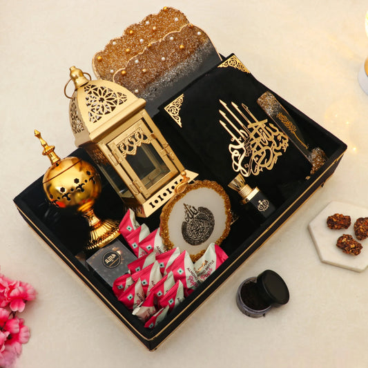 Ramadan Kareem Hamper Gifts - Premium Essentials featuring Quran, bakhoor burner, ittar, prayer beads, and sweets in a velvet tray.