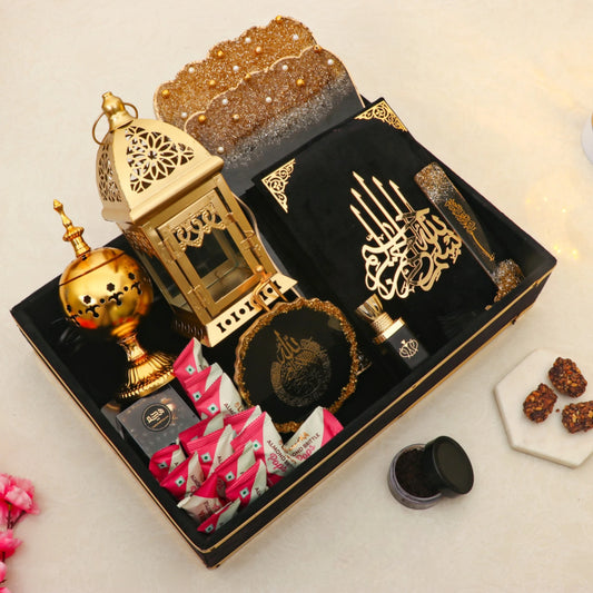 Elegant Ramadan Kareem Hamper Gifts with golden lantern, bakhoor burner, Quran, ittar, and premium treats for Eid-ul-Fitr celebrations.