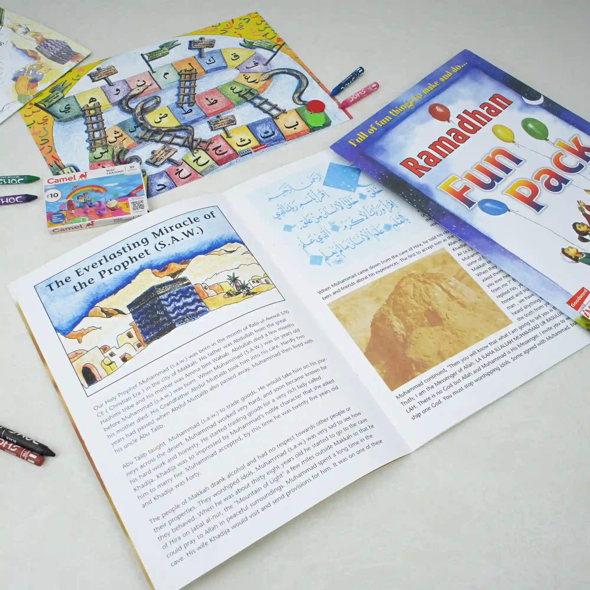 Educational materials including a book and colorful cards on a white surface