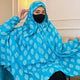 Woman wearing blue printed cotton prayer hijab with black face mask