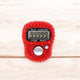 Close-up of red digital tasbeeh counter showing 99999. Elegant and functional for daily zikr practice.