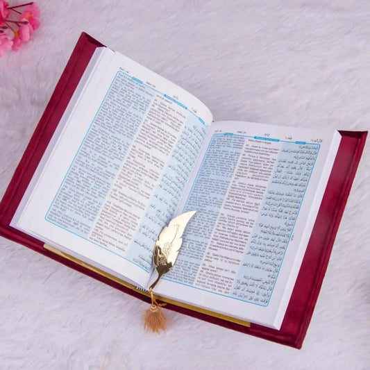 Open Velvet Quran Translation in red with bilingual Arabic-English text and gold feather bookmark, perfect for religious gifting.