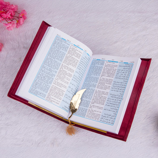 Open velvet Quran with blue translation pages and feather bookmark from the Maroon Sequence Rehal Hamper - Luxury Quran Gift Set. Bilingual edition.