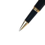 Black pen with gold accents on a white background