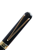 Black pen with gold accents on a white background