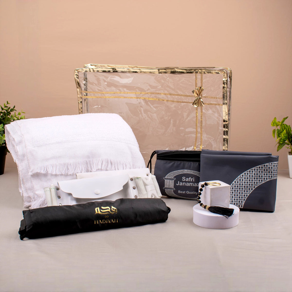 Complete Safar-e-Imaan Men's Set for Hajj and Umrah including Ihram towel, white belt, black drawstring bag, tasbeeh, and compact prayer mat.