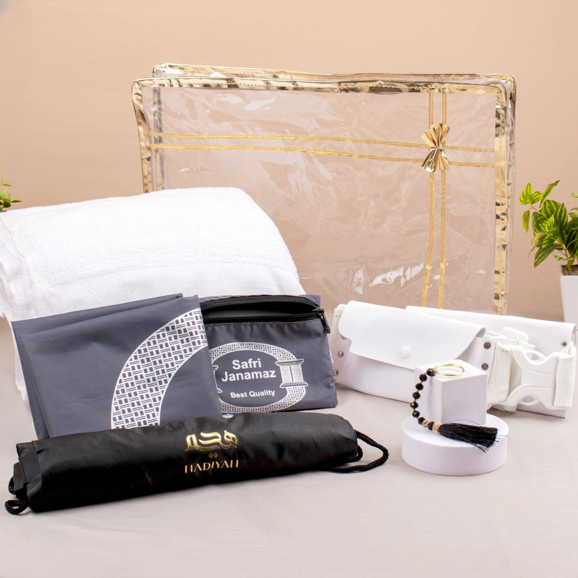 Safar-e-Imaan Men's Set - Umrah Hajj essentials set with Ihram towel, belt, sling bag, tasbeeh, and travel janamaz in a transparent gold-trimmed case. Main image