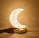 Close-up of Crystal Touch Moon Lamp being activated by touch, showcasing warm light mode for spiritual ambiance and home decor.