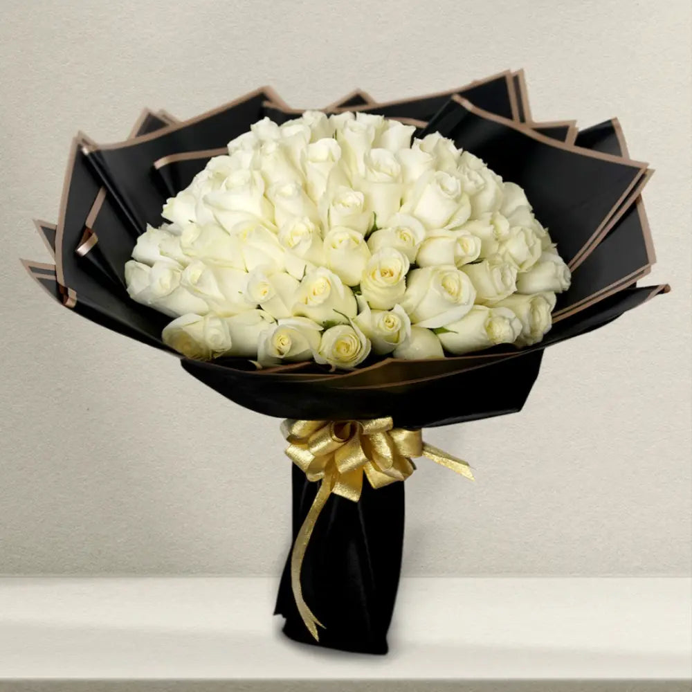 Elegant Peaceful White Roses Bouquet featuring 100 white rose stems wrapped in black paper with gold ribbon, perfect for sympathy or special occasions.