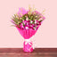Purple Orchid Bouquet wrapped in vibrant pink paper with white ribbon, ideal for anniversaries or same day delivery gifts.
