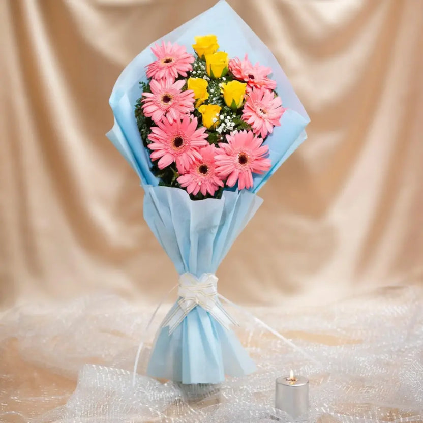 Forever Blossom Bouquet featuring pink gerberas and yellow roses wrapped in blue paper, perfect romantic rose bouquet for anniversaries or weddings. Main image