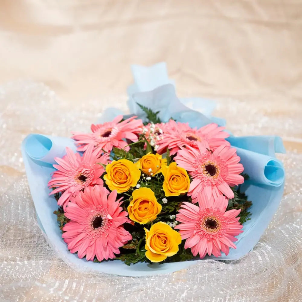 Only You Forever Blossom Bouquet with vibrant pink gerberas and yellow roses laid flat, ideal for romantic gift giving and same day delivery.